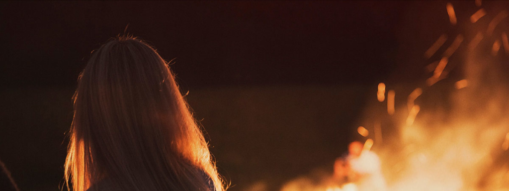 Women in front of bonfire