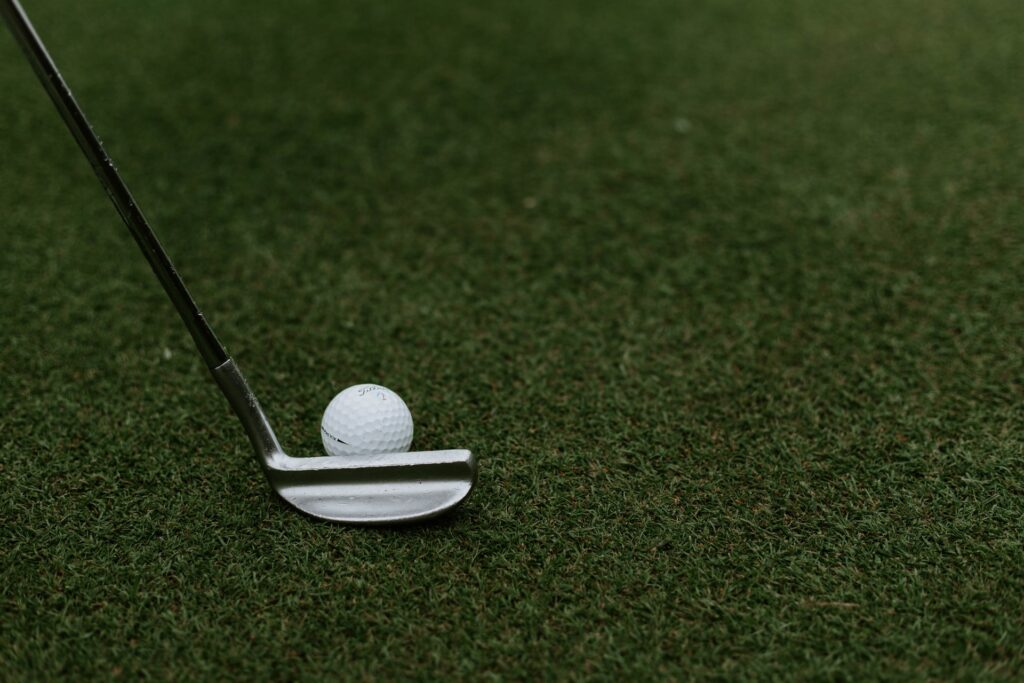 Close-up image of a golf club and ball at a sports facility