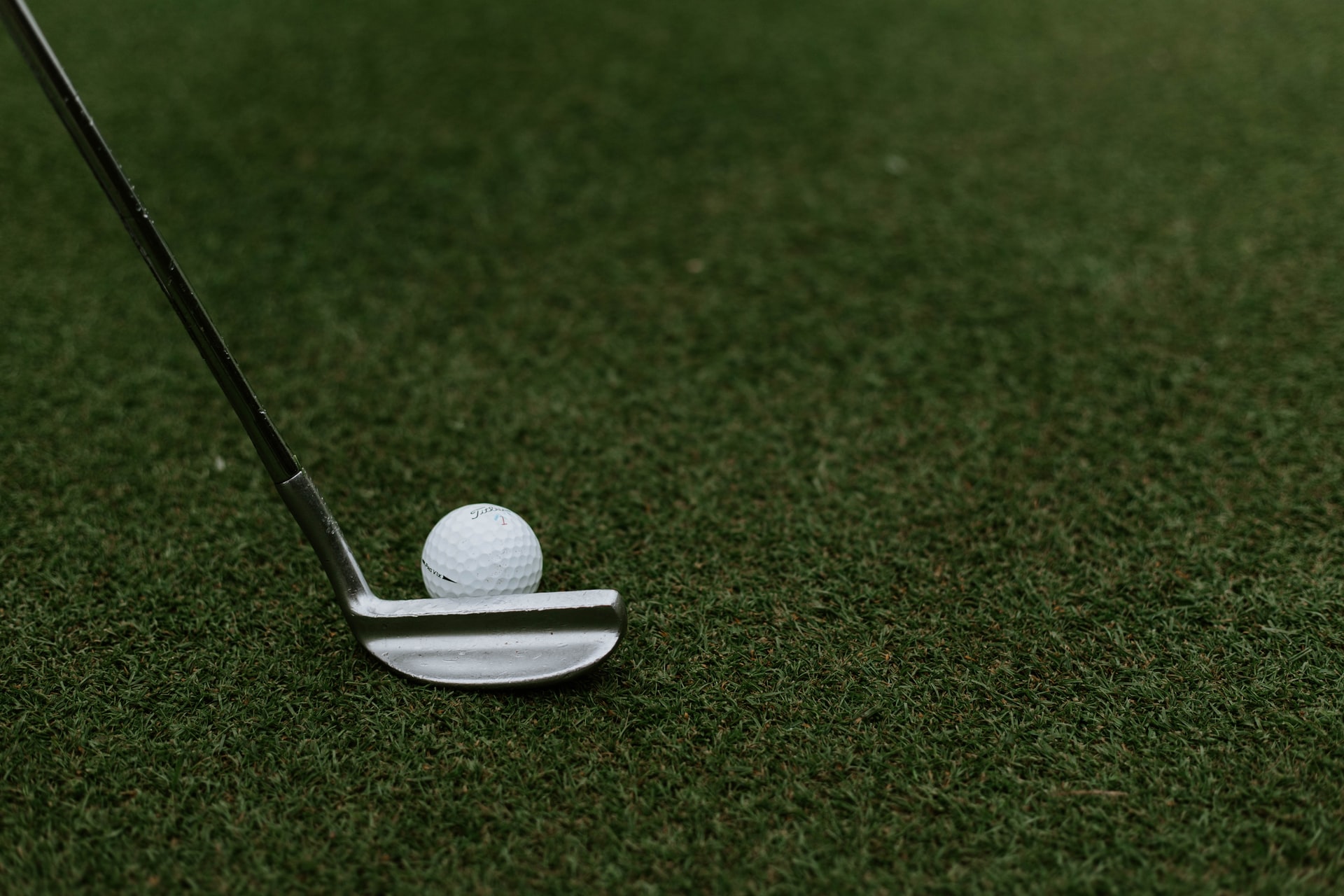 Close-up image of a golf club and ball at a sports facility